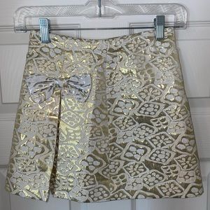 gold and white metallic skirt with bow